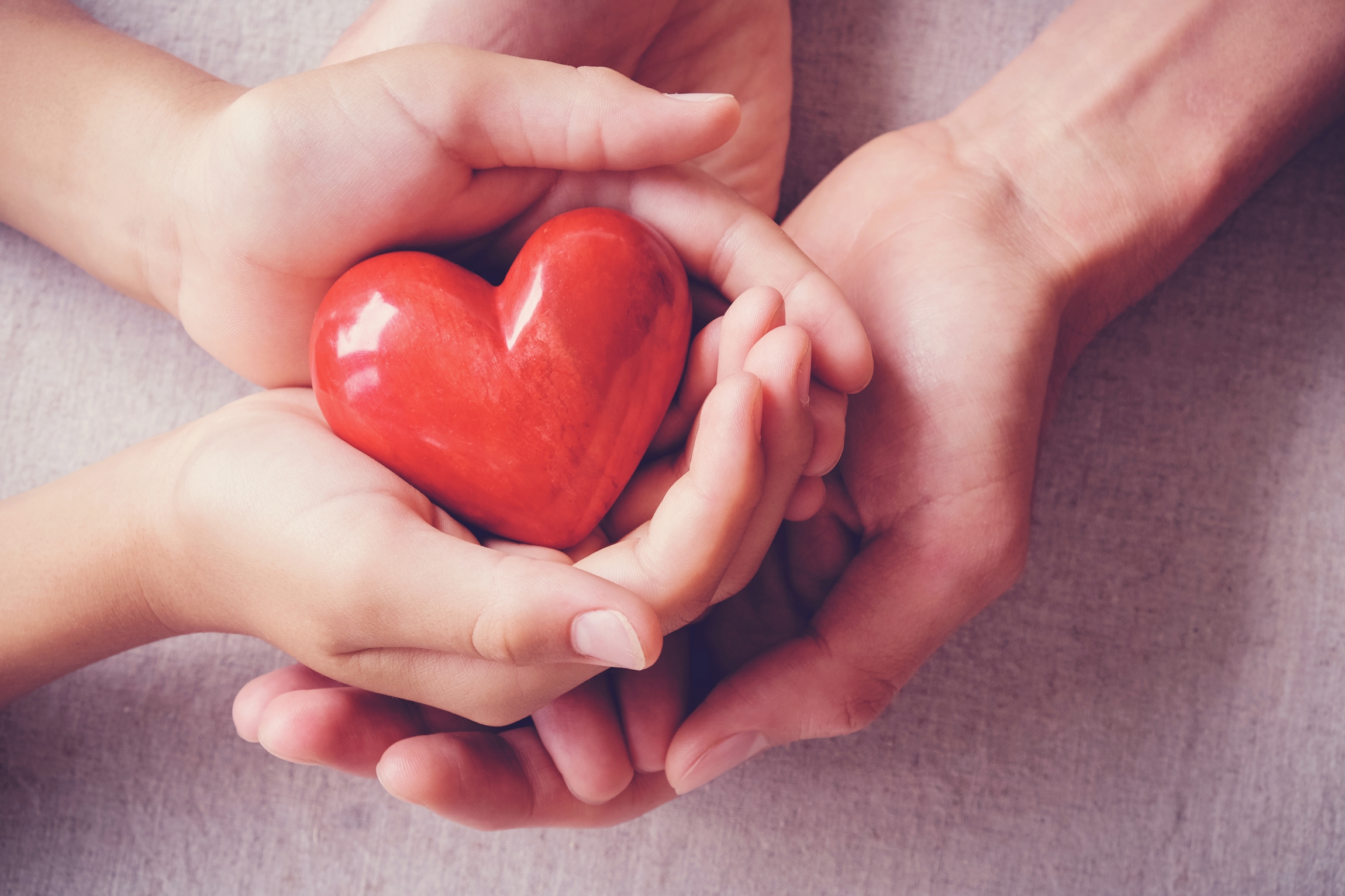 hands-holiding-red-heart-health-care-family-concept